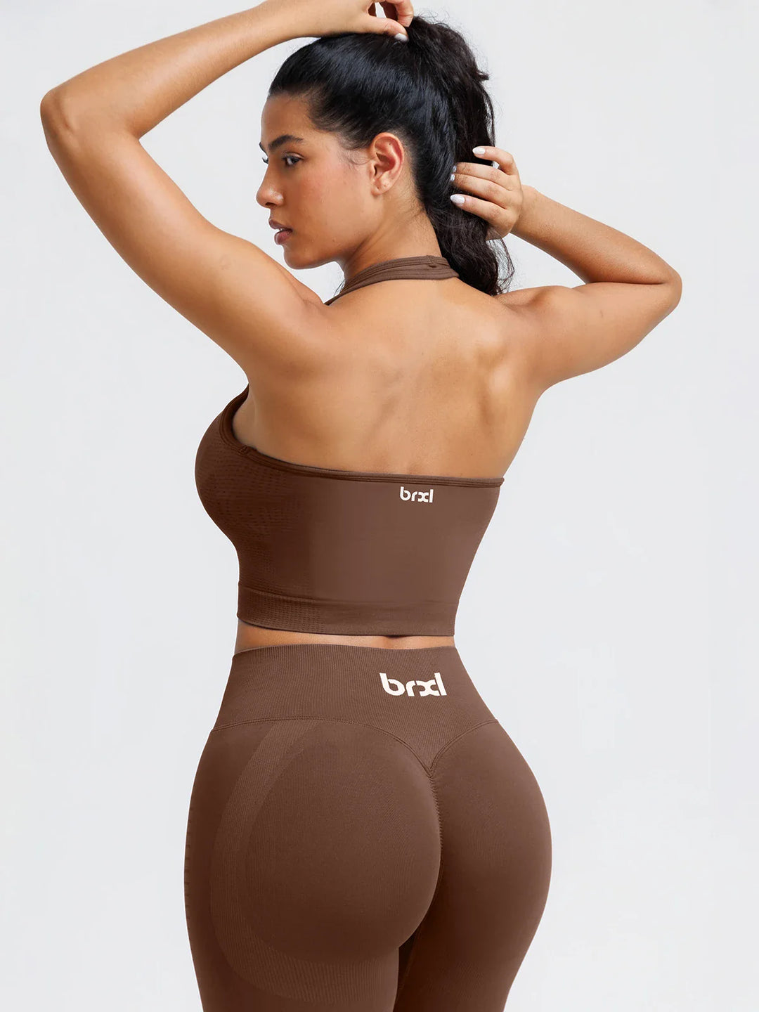 A model wearing a BRXL® BrxlZero® Seamless Ribbed Scoop-Neck Halter Sports Tank Top