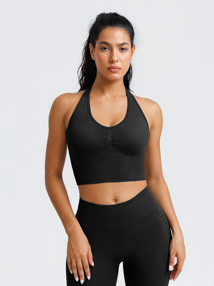 A model wearing a BRXL® BrxlZero® Seamless Ribbed Scoop-Neck Halter Sports Tank Top Black / XS