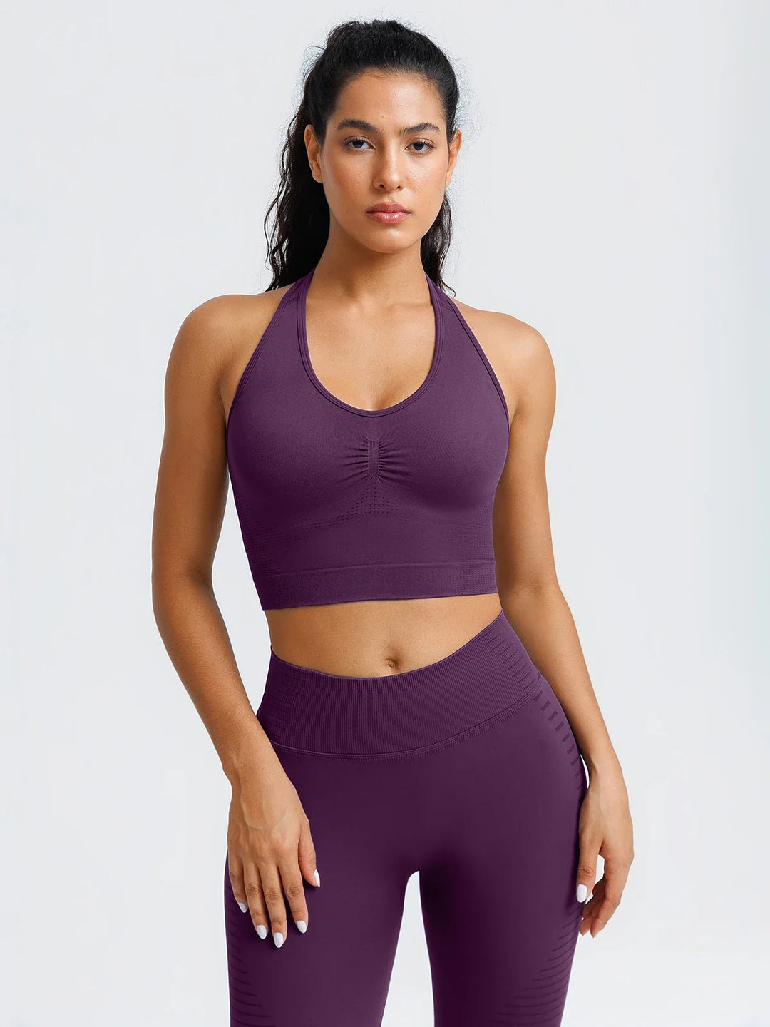 A model wearing a BRXL® BrxlZero® Seamless Ribbed Scoop-Neck Halter Sports Tank Top Dark Plum / XS