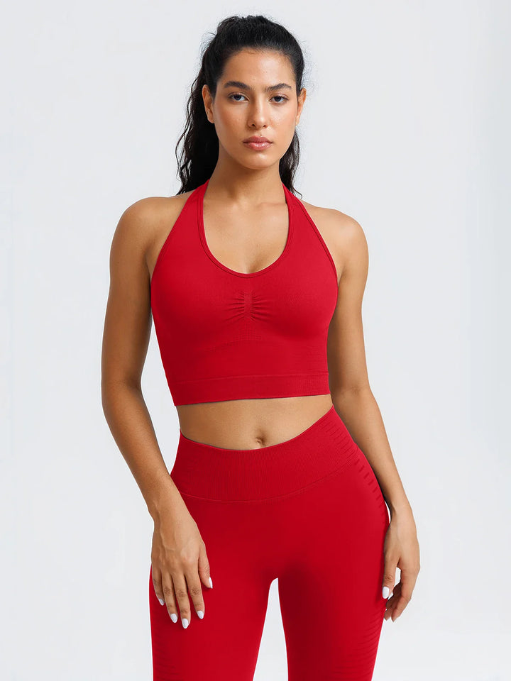 A model wearing a BRXL® BrxlZero® Seamless Ribbed Scoop-Neck Halter Sports Tank Top Ruby Red / XS