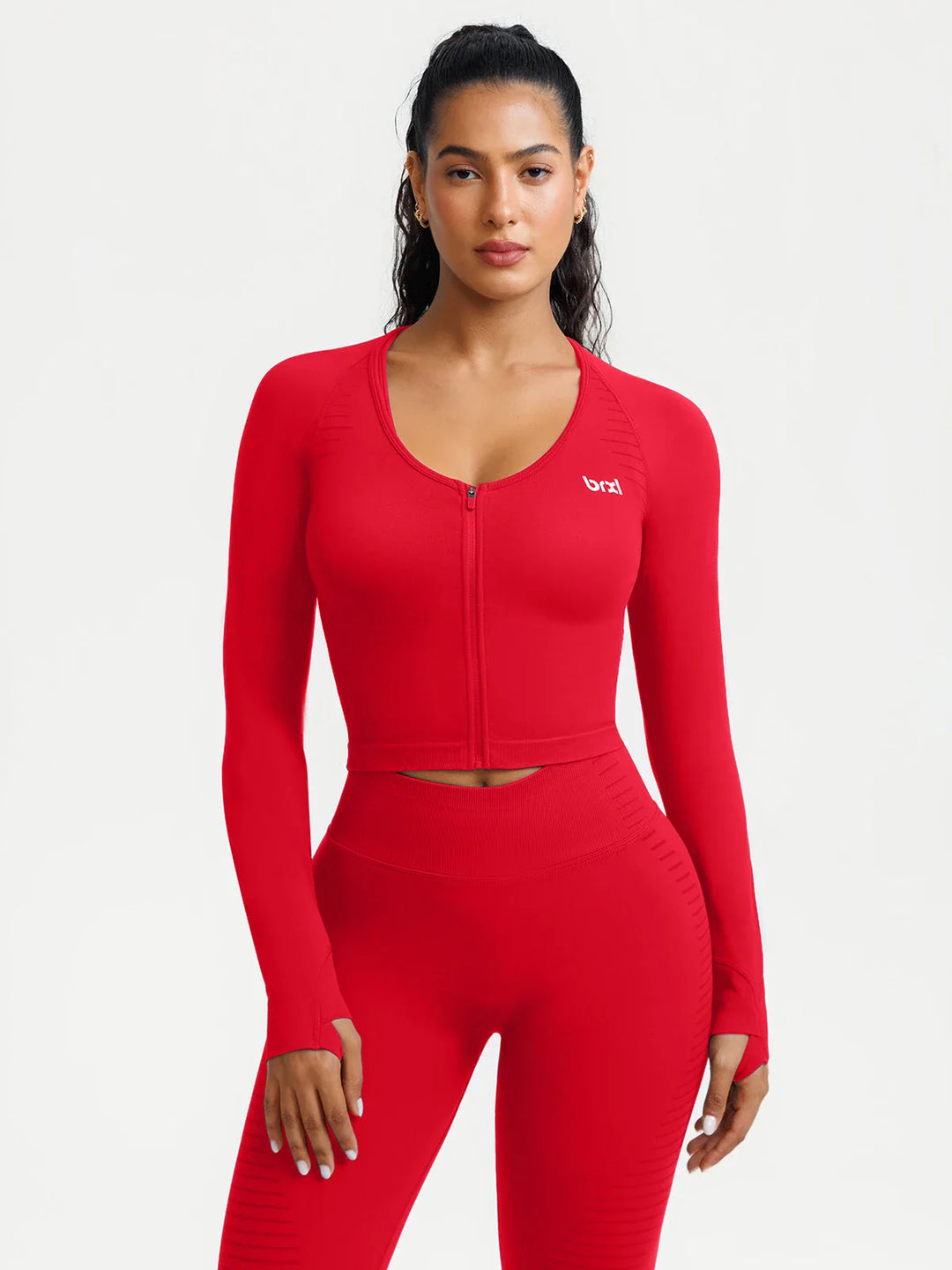 A model wearing a BRXL® BrxlZero® Seamless Scoop-Neck Long Sleeve Cropped Jacket Ruby Red / XS