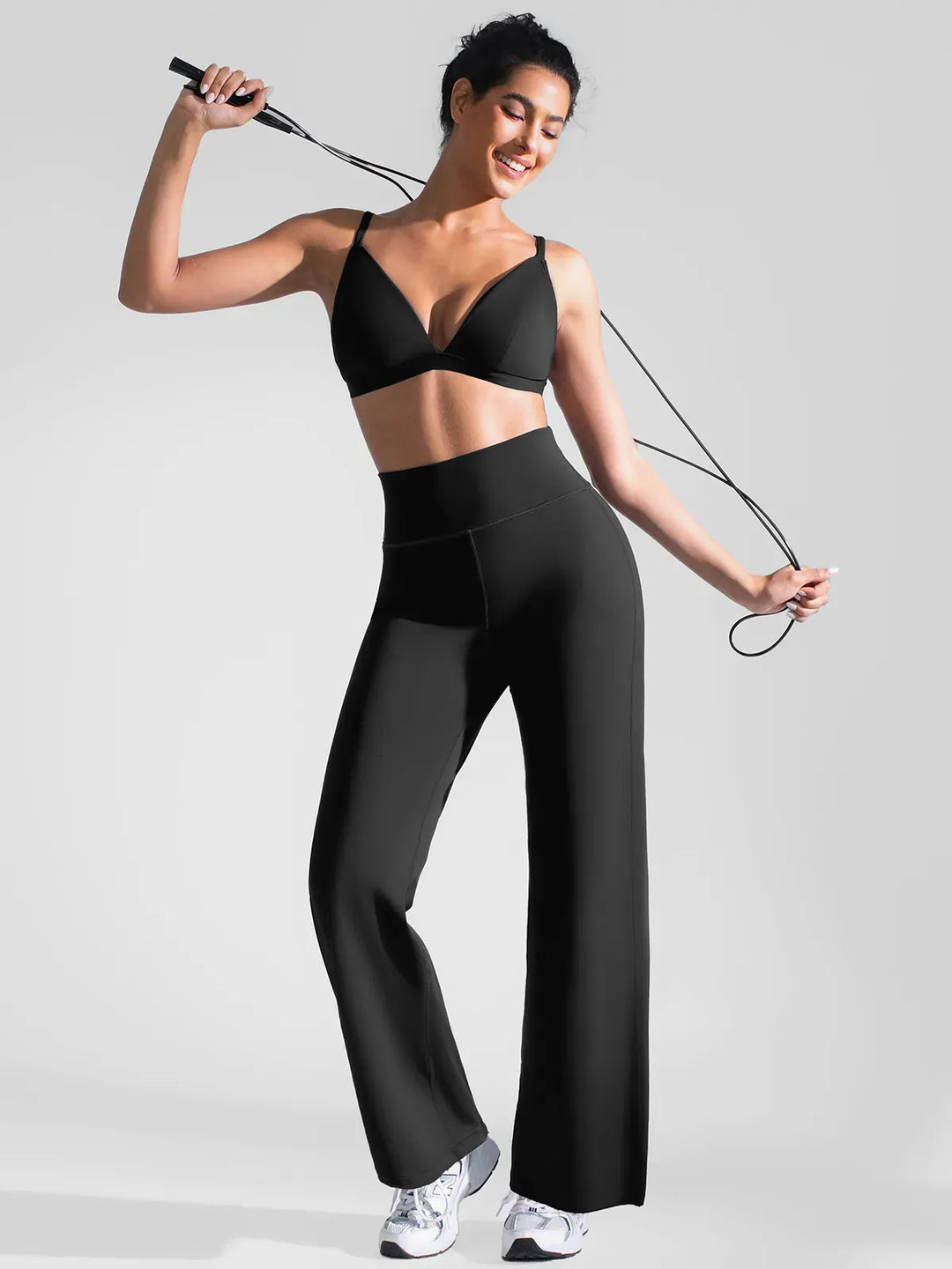 A model wearing a BRXL® Butt Lift Wide Leg Workout Pants in