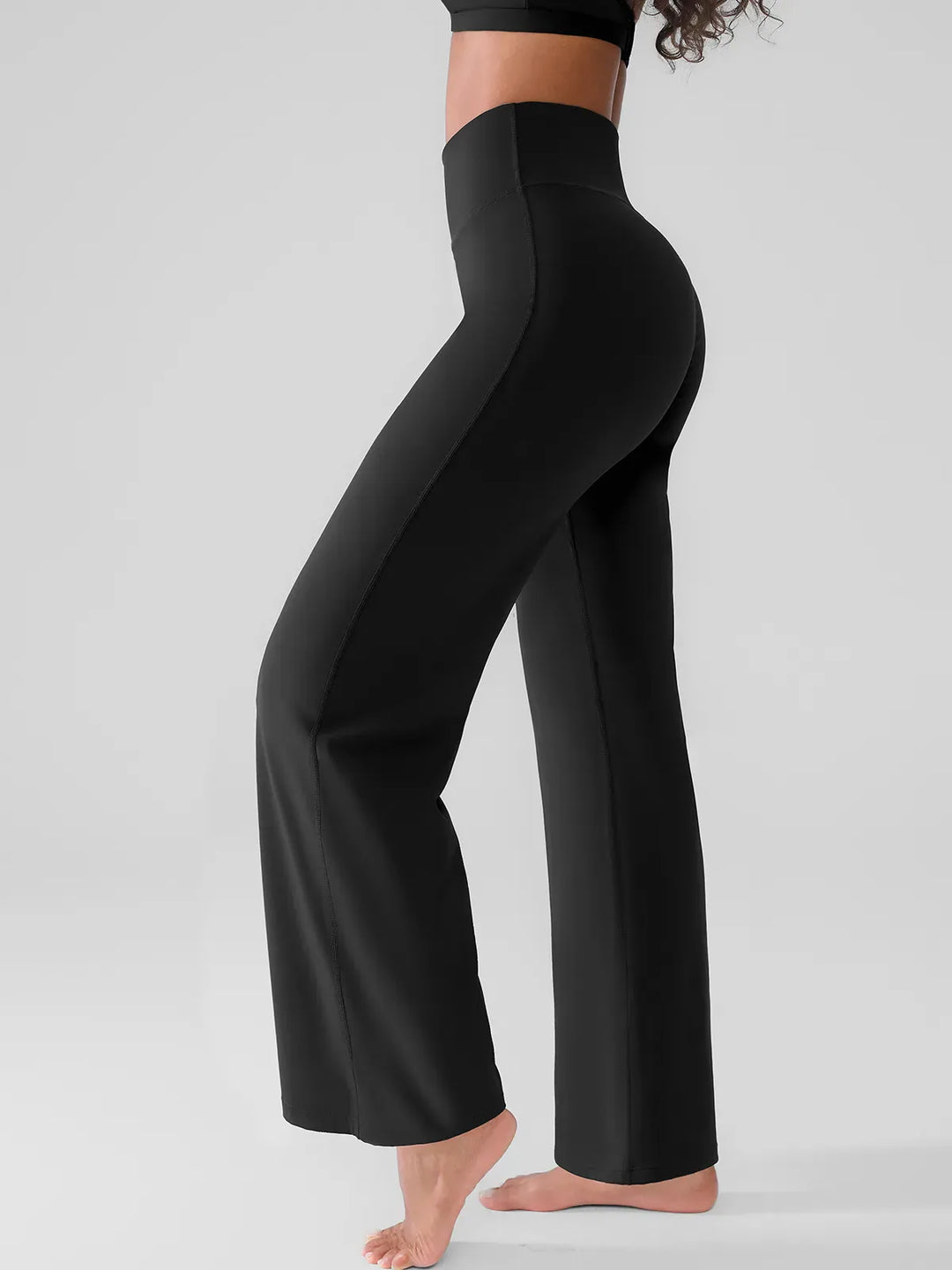 A model wearing a BRXL® Butt Lift Wide Leg Workout Pants in