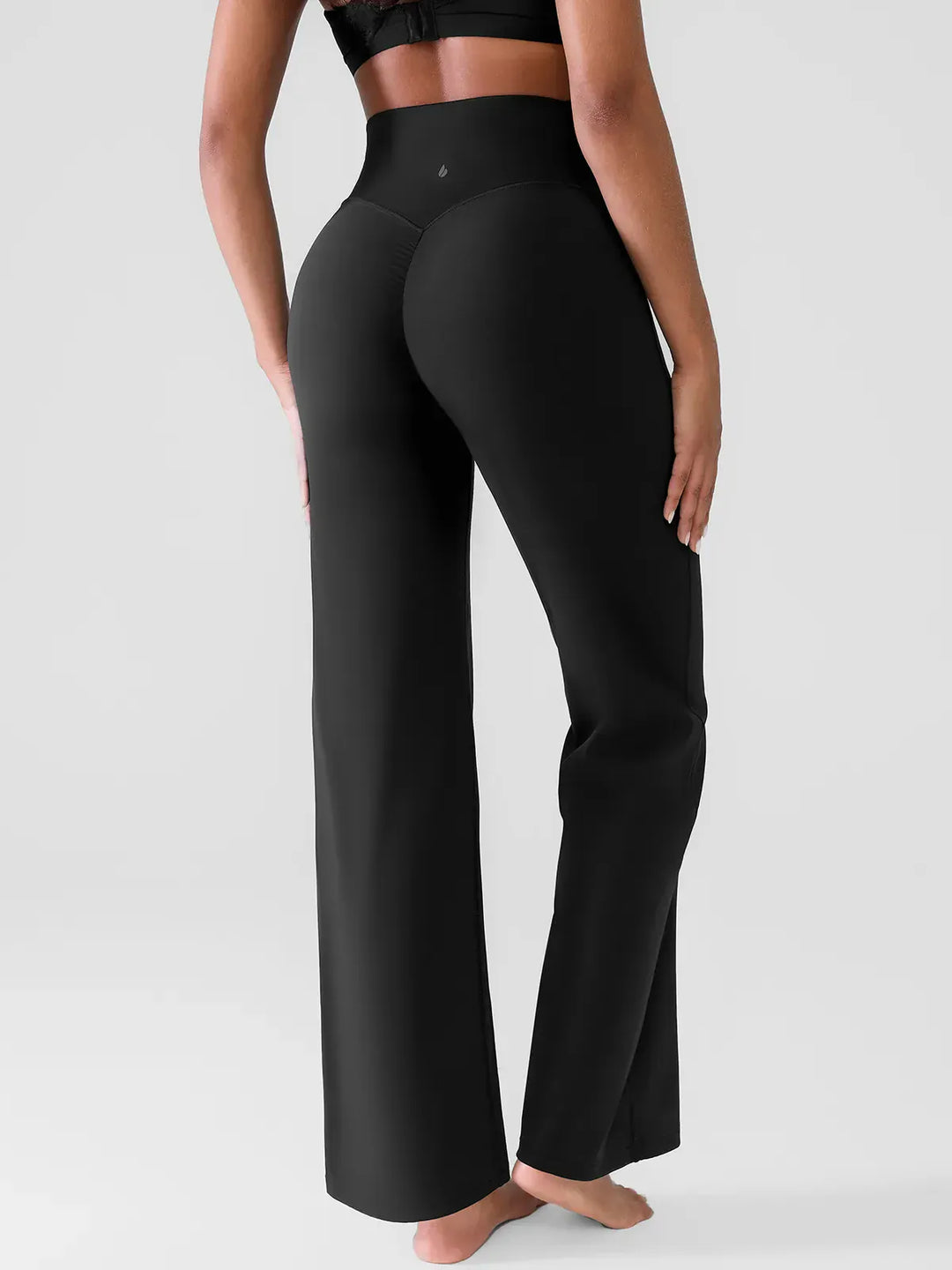 A model wearing a BRXL® Butt Lift Wide Leg Workout Pants in