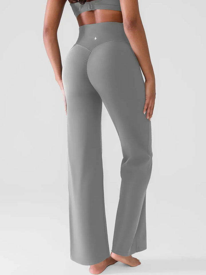 A model wearing a BRXL® Butt Lift Wide Leg Workout Pants in