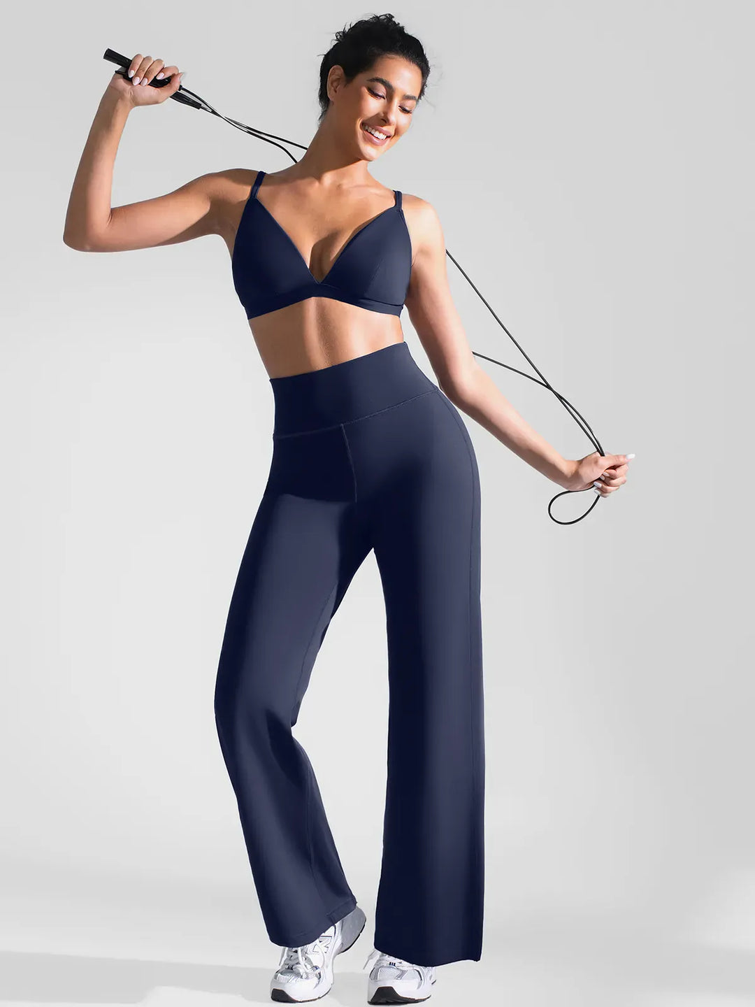 A model wearing a BRXL® Butt Lift Wide Leg Workout Pants in
