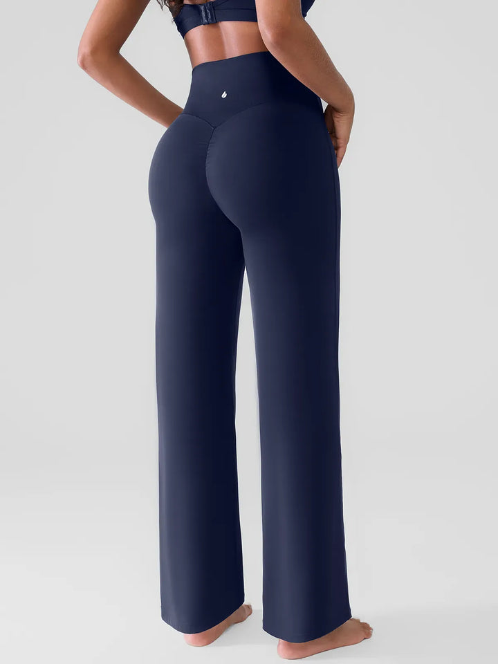 A model wearing a BRXL® Butt Lift Wide Leg Workout Pants in