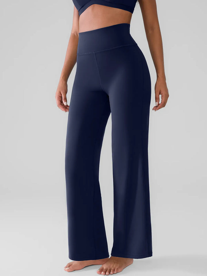 A model wearing a BRXL® Butt Lift Wide Leg Workout Pants in