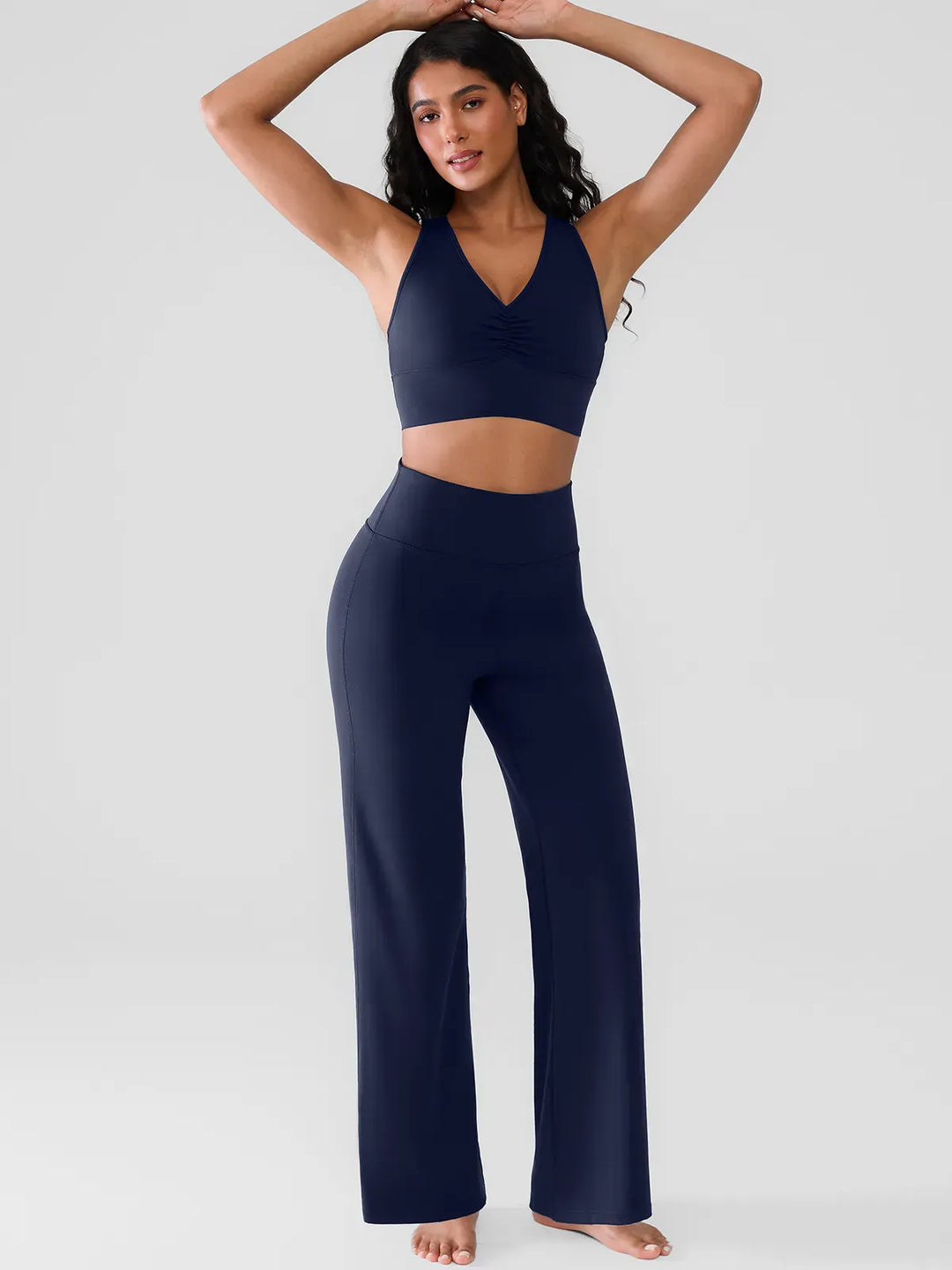 A model wearing a BRXL® Butt Lift Wide Leg Workout Pants in