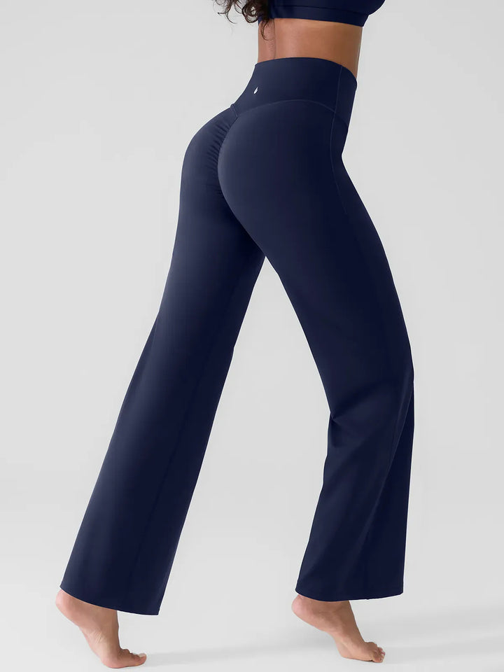 A model wearing a BRXL® Butt Lift Wide Leg Workout Pants in Blue / XS