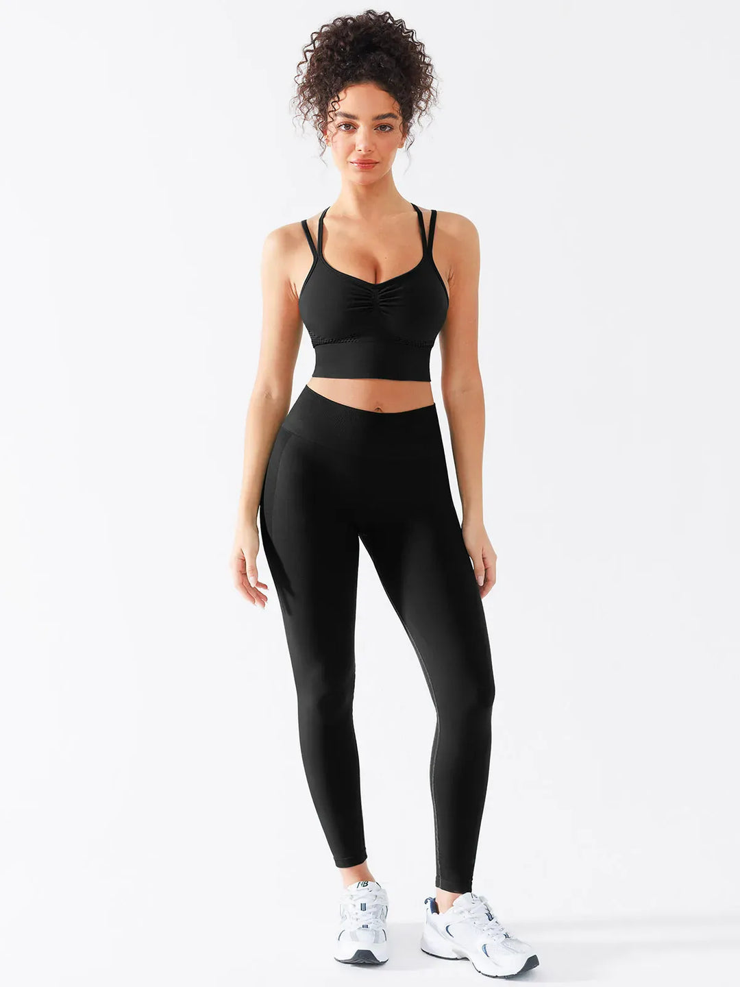 A model wearing a BRXL® Butt Lifting Seamless Bra Scrunch Leggings Set in