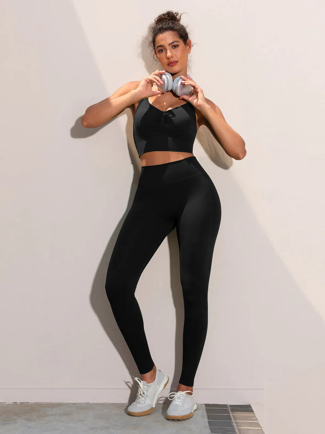 A model wearing a BRXL® Butt Lifting Seamless Bra Scrunch Leggings Set in Set / Black / XS
