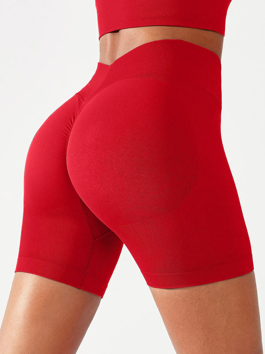 A model wearing a BRXL® Butt Lifting Seamless Bra Scrunch Leggings Set in Shorts / Red / XS