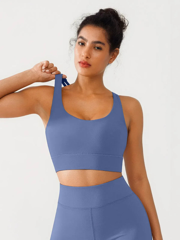 A model wearing a BRXL® Criss Cross Strappy Yoga Sports Bra