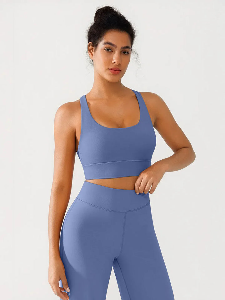 A model wearing a BRXL® Criss Cross Strappy Yoga Sports Bra in