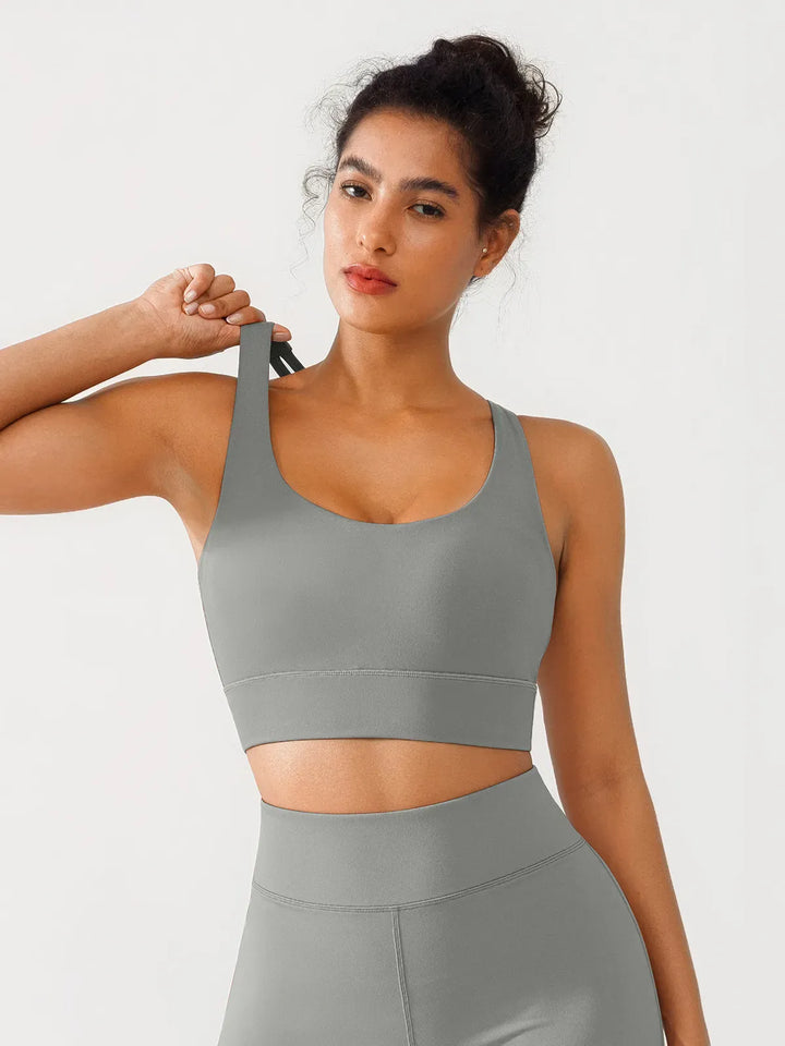 A model wearing a BRXL® Criss Cross Strappy Yoga Sports Bra