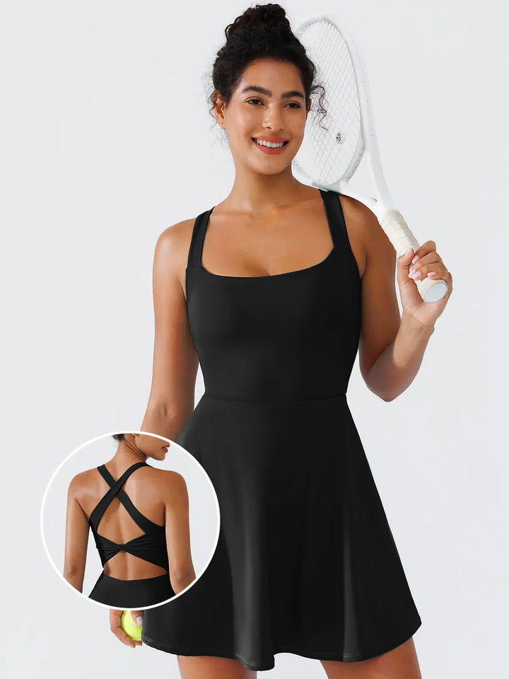 A model wearing a BRXL® CrissCross Back Sun Protection Tennis Dress