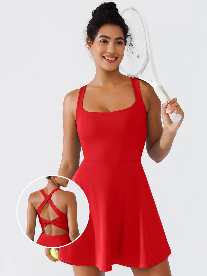 A model wearing a BRXL® CrissCross Back Sun Protection Tennis Dress