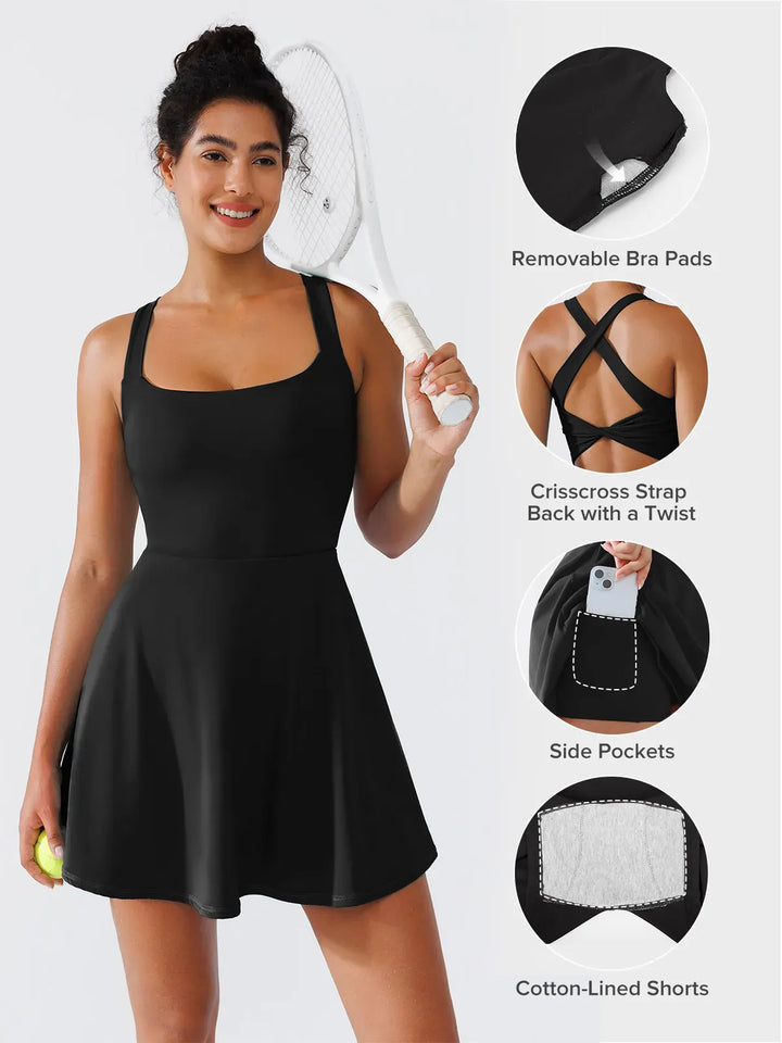 A model wearing a BRXL® CrissCross Back Sun Protection Tennis Dress in