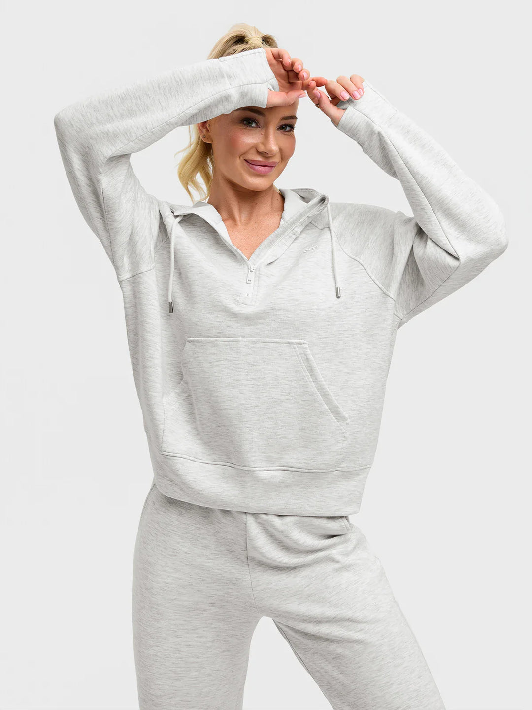 A model wearing a BRXL® Cropped Half-Zip Pullover Comfort Hoodie
