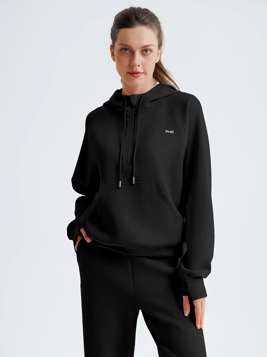 A model wearing a BRXL® Cropped Half-Zip Pullover Comfort Hoodie Black / XS