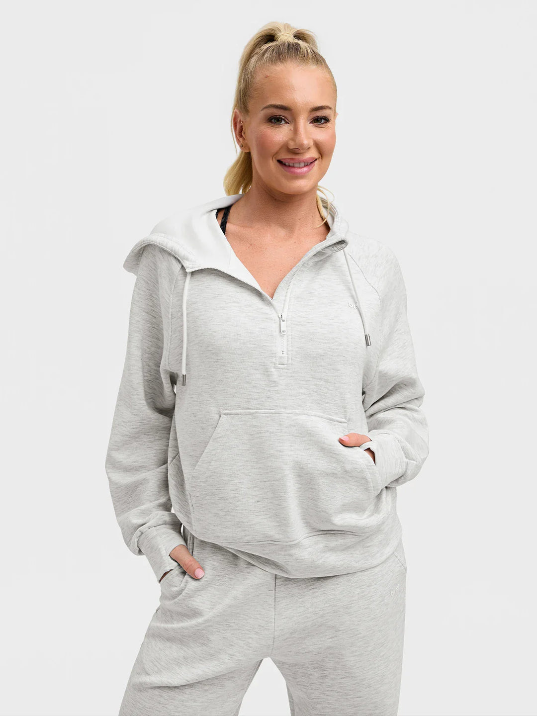 A model wearing a BRXL® Cropped Half-Zip Pullover Comfort Hoodie Charcoal Grey / XS