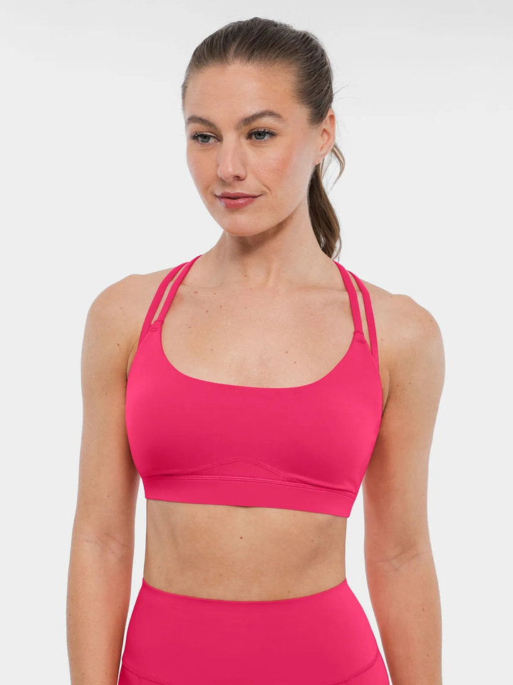 A model wearing a BRXL® Cross Strap Sports Bra High-Waisted Shorts Set in