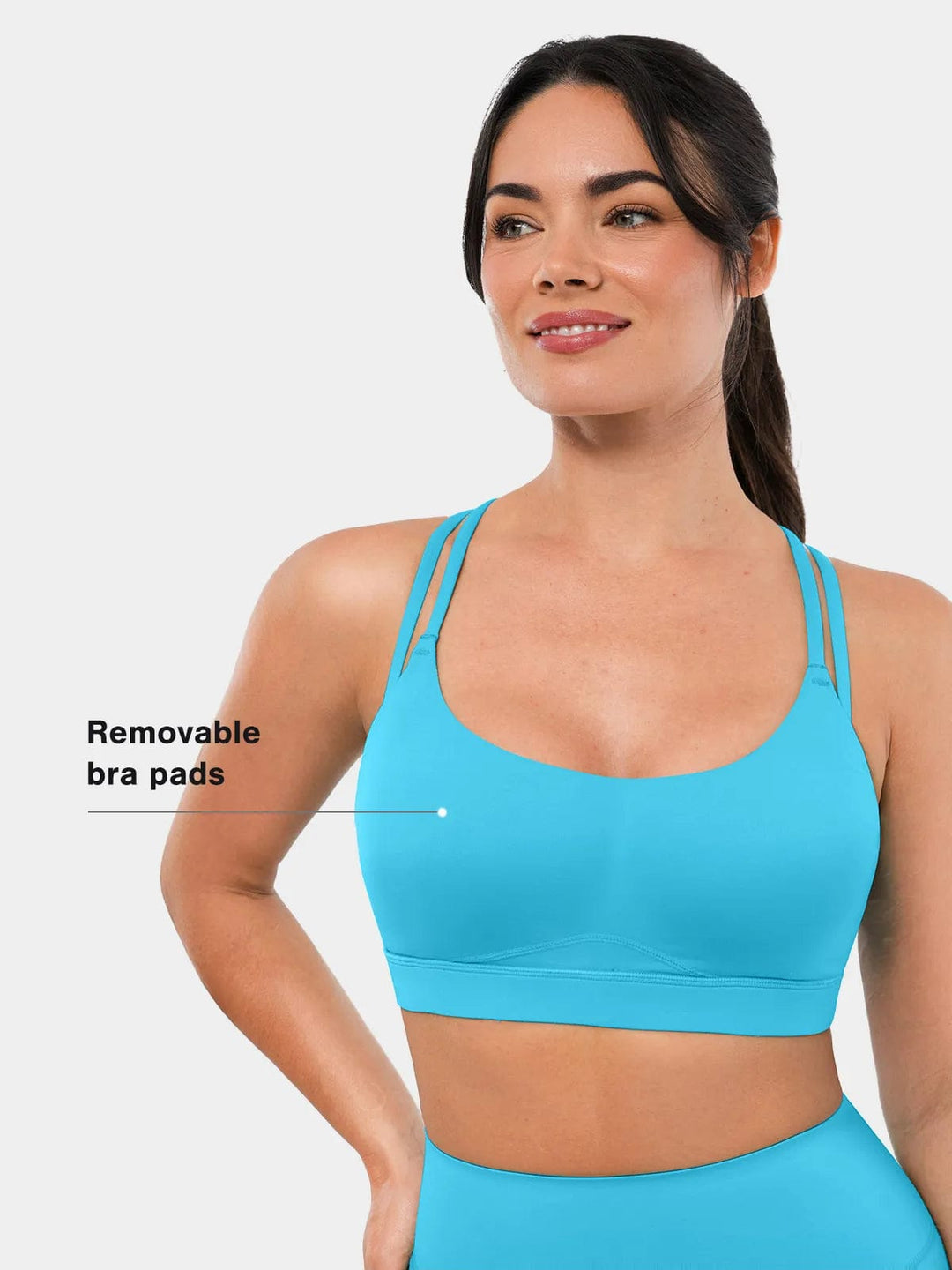 A model wearing a BRXL® Cross Strap Sports Bra Sculpted Leggings Set in