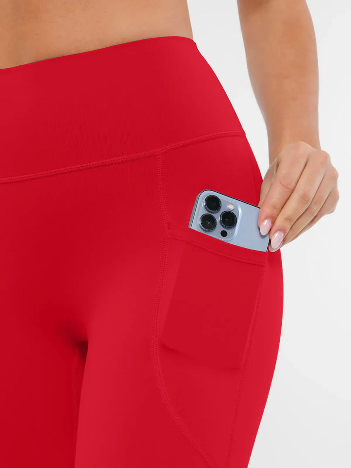 A model wearing a BRXL® Cross Strap Sports Bra Sculpted Leggings Set in