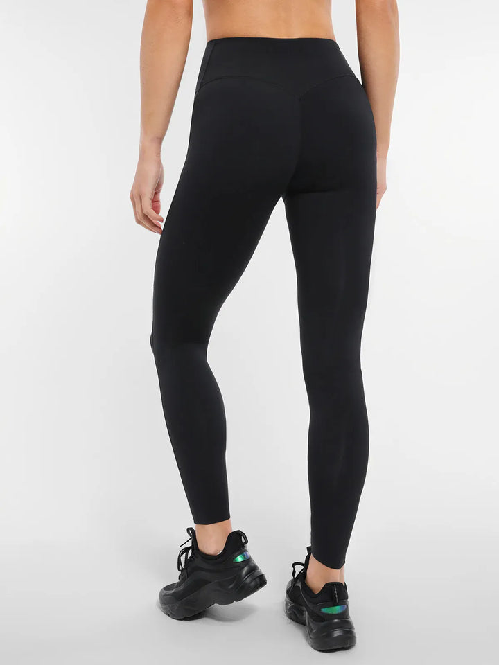 A model wearing a BRXL® Cross Strap Sports Bra Sculpted Leggings Set in