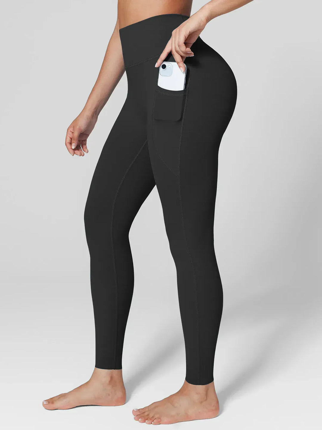 A model wearing a BRXL® Cross Strap Sports Bra Sculpted Leggings Set in