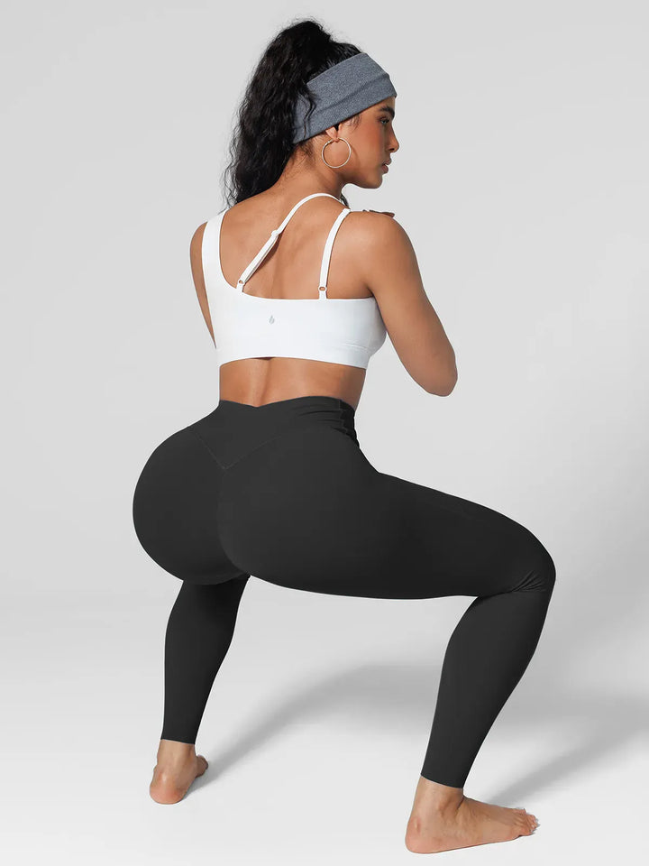 A model wearing a BRXL® Cross Strap Sports Bra Sculpted Leggings Set