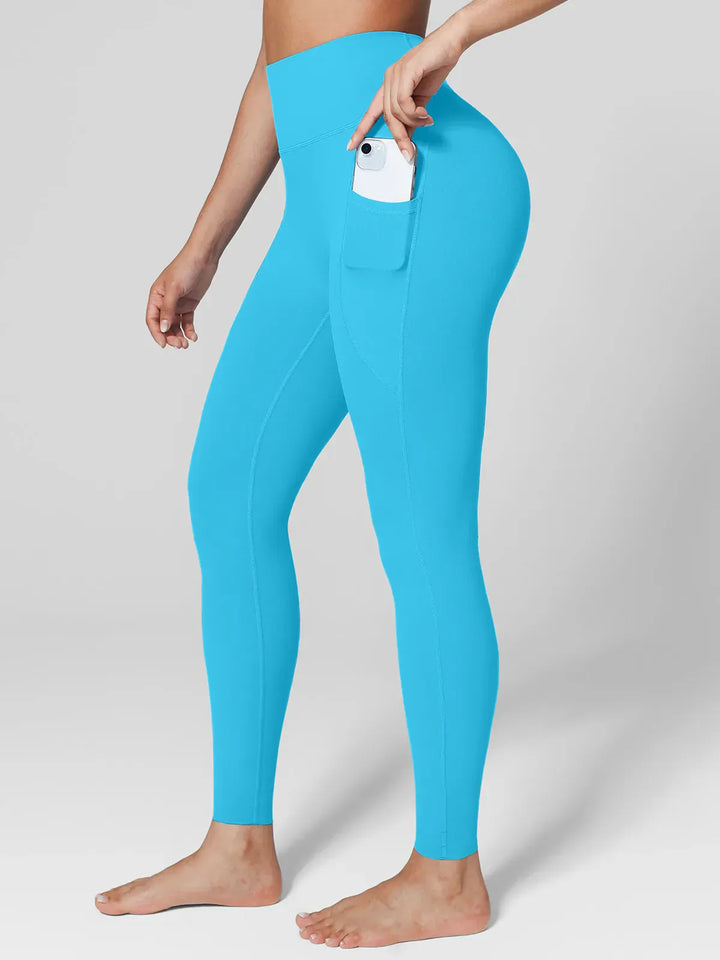 A model wearing a BRXL® Cross Strap Sports Bra Sculpted Leggings Set in