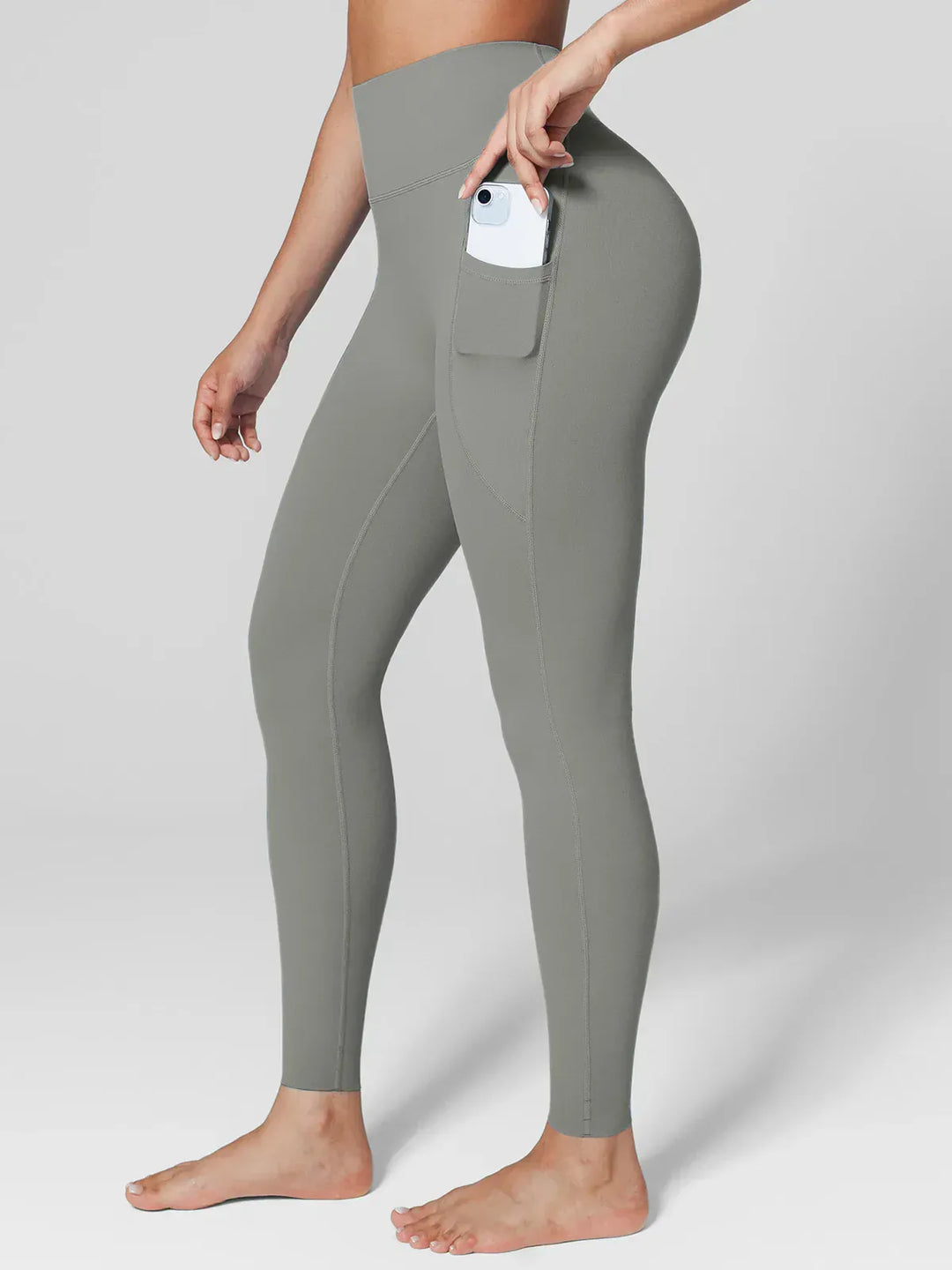 A model wearing a BRXL® Cross Strap Sports Bra Sculpted Leggings Set