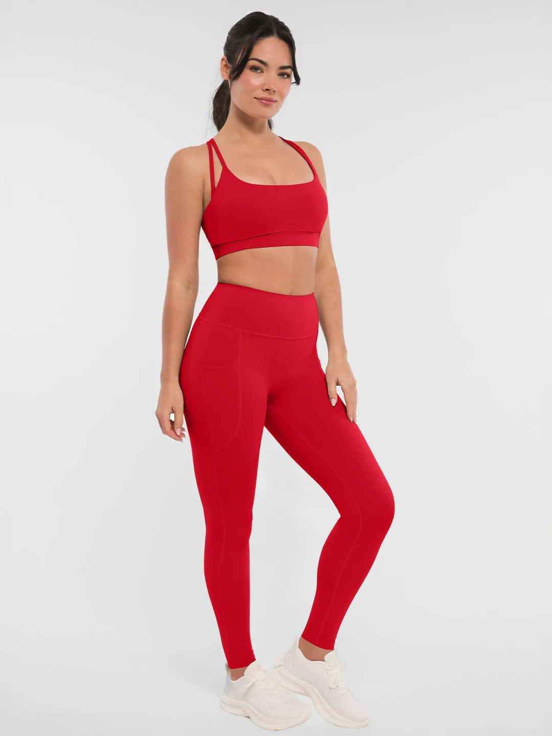 A model wearing a BRXL® Cross Strap Sports Bra Sculpted Leggings Set (Copy) Set / Red / XS