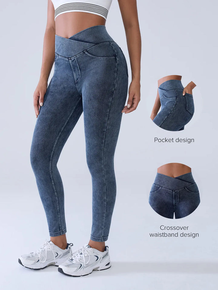A model wearing a BRXL® Crossover Denim Sculpting Leggings with Pockets in