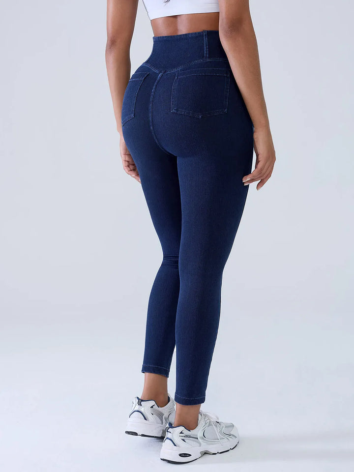 A model wearing a BRXL® Crossover Denim Sculpting Leggings with Pockets in