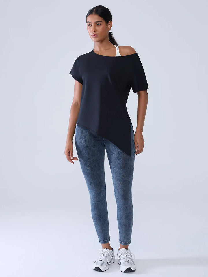 A model wearing a BRXL® Crossover Denim Sculpting Leggings with Pockets in