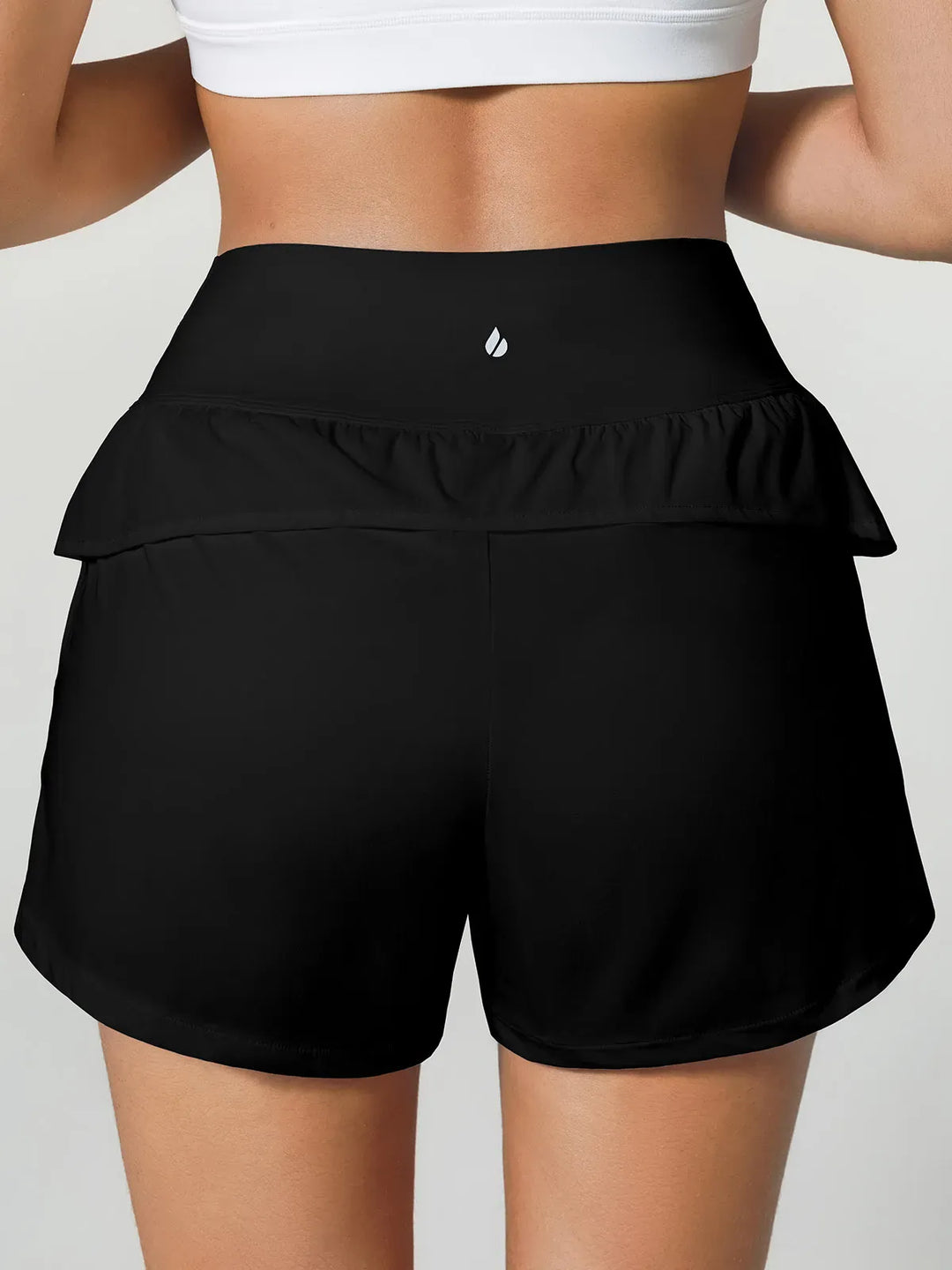 A model wearing a BRXL® Crossover Ruffled Flowy Shorts in