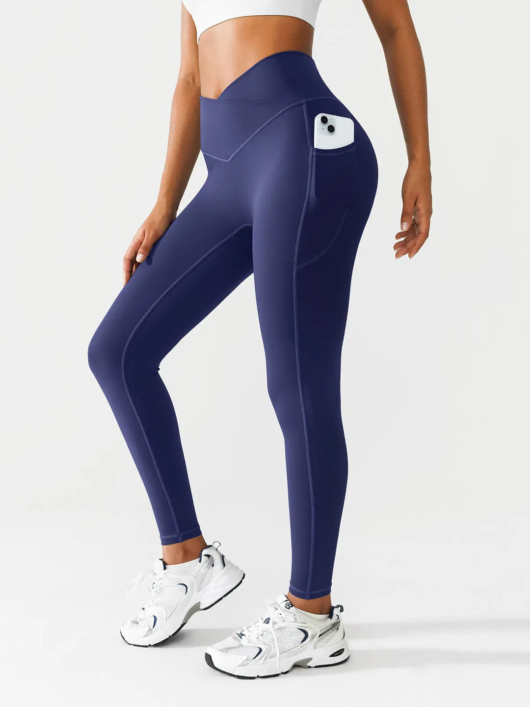 A model wearing a BRXL® Crossover Running Leggings with Pockets in