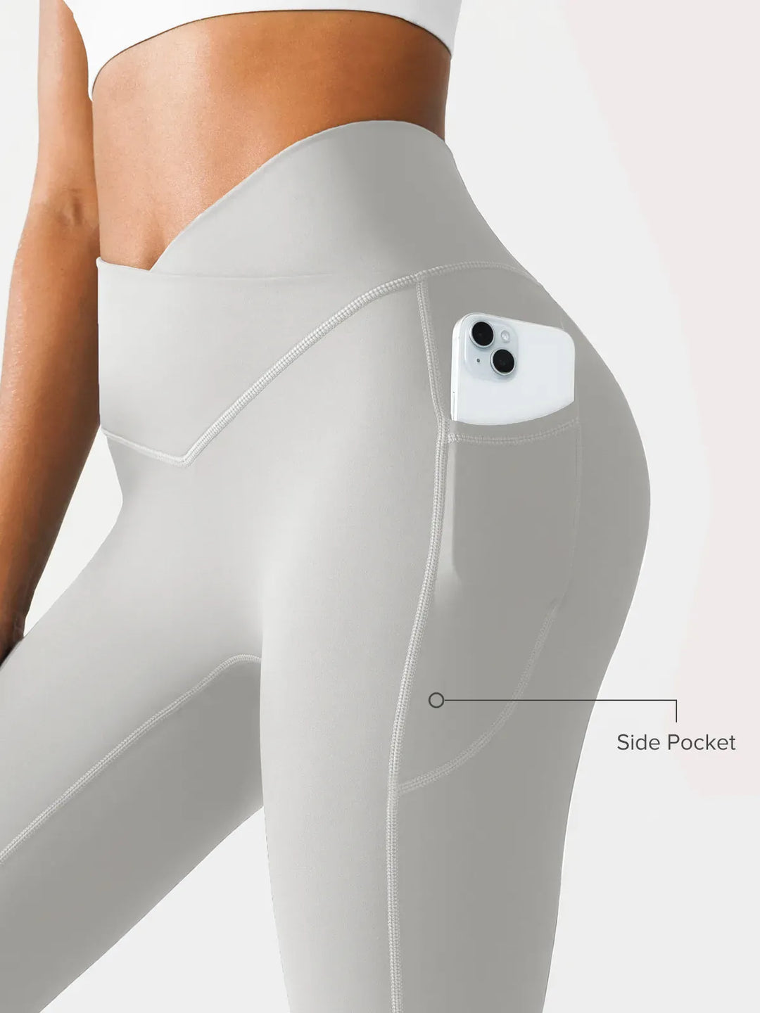 A model wearing a BRXL® Crossover Running Leggings with Pockets in