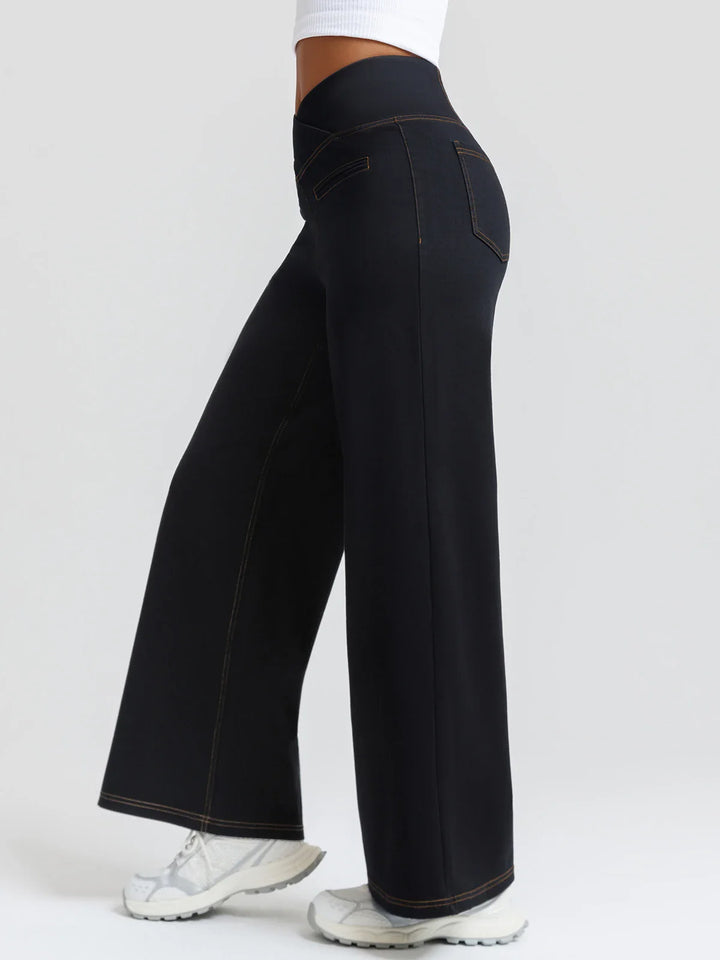 A model wearing a BRXL® Crossover Tummy Control Casual Wide Leg Jeans with Pockets
