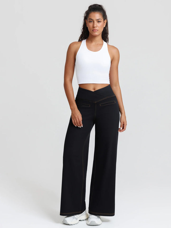 A model wearing a BRXL® Crossover Tummy Control Casual Wide Leg Jeans with Pockets