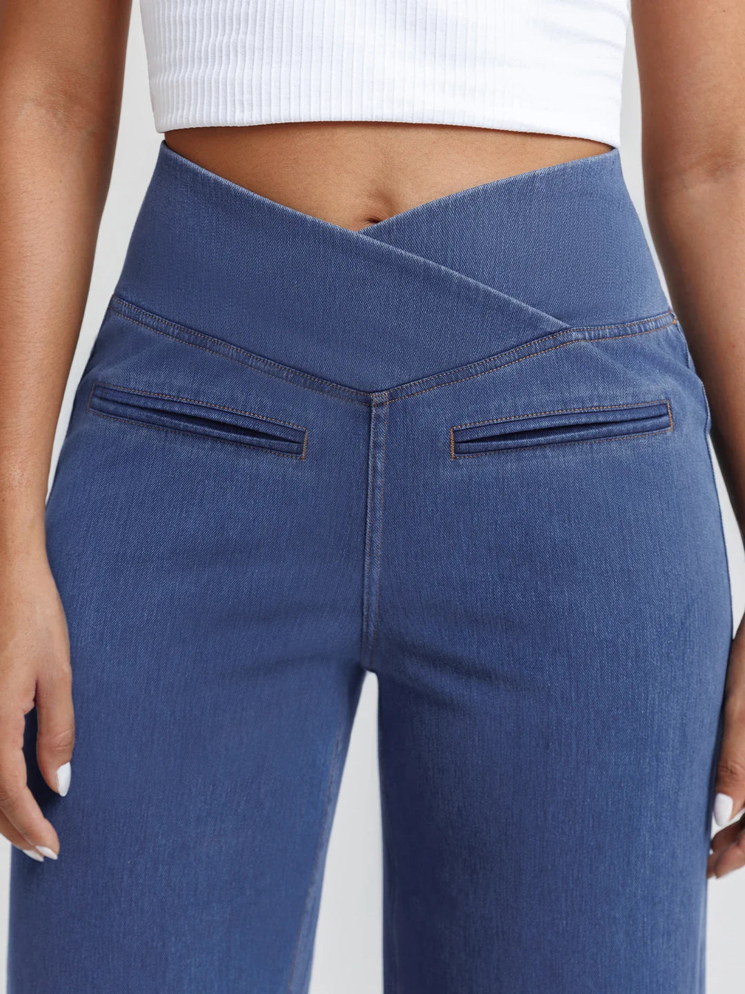 A model wearing a BRXL® Crossover Tummy Control Casual Wide Leg Jeans with Pockets