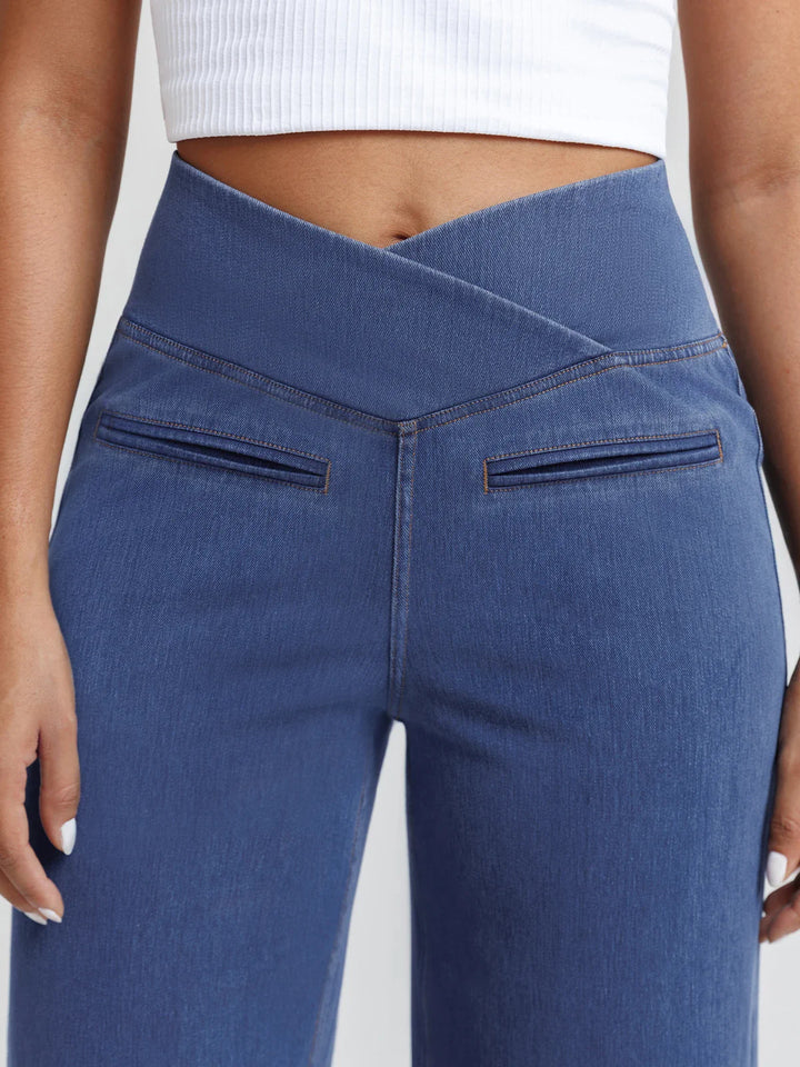 A model wearing a BRXL® Crossover Tummy Control Casual Wide Leg Jeans with Pockets