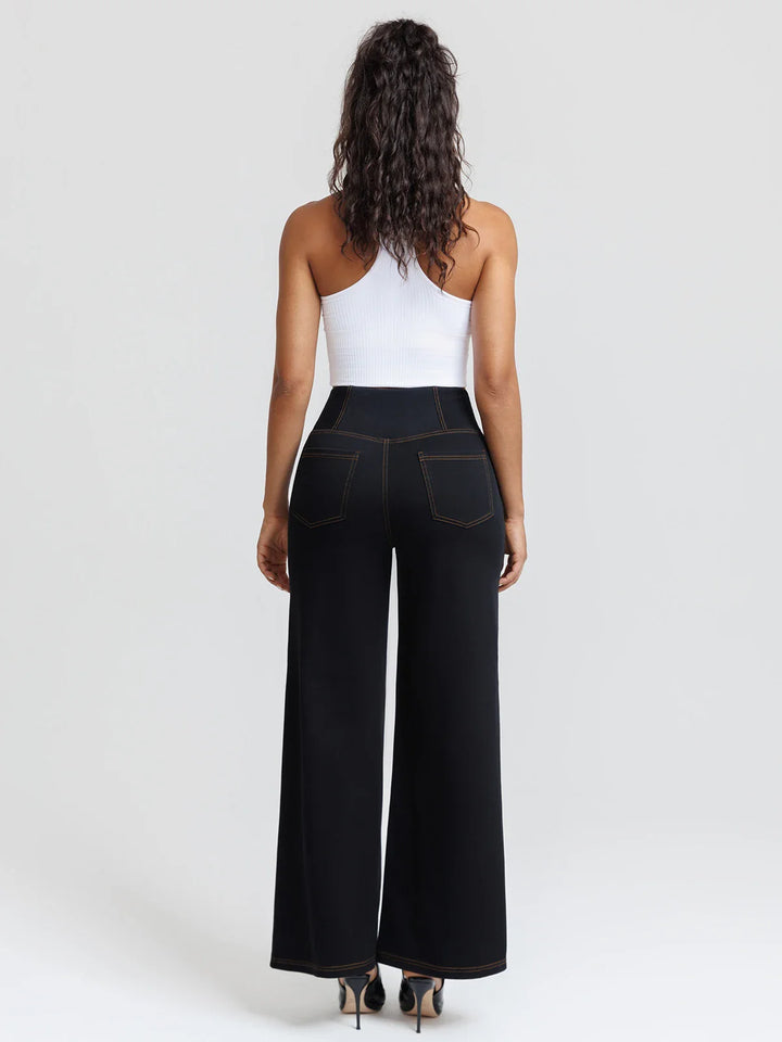 A model wearing a BRXL® Crossover Tummy Control Casual Wide Leg Jeans with Pockets