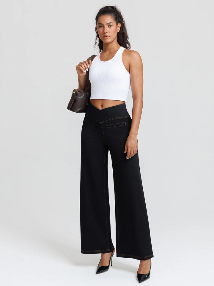 A model wearing a BRXL® Crossover Tummy Control Casual Wide Leg Jeans with Pockets