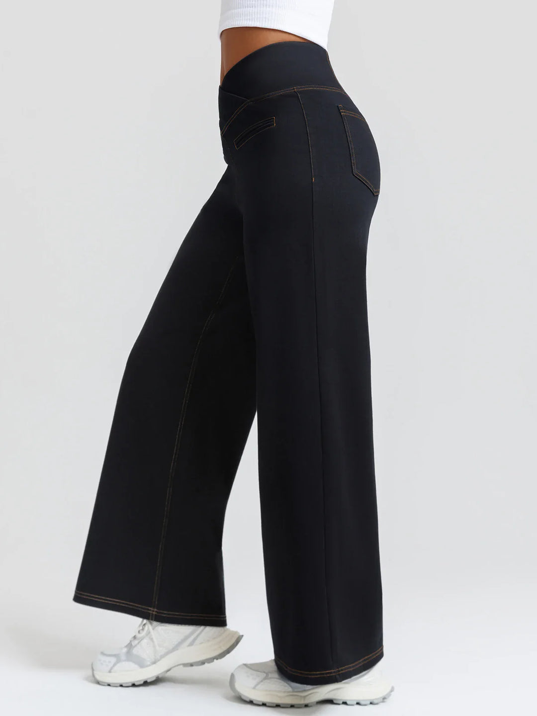A model wearing a BRXL® Crossover Tummy Control Casual Wide Leg Jeans with Pockets