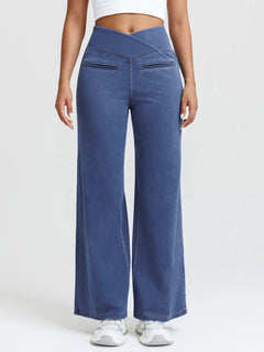 A model wearing a BRXL® Crossover Tummy Control Casual Wide Leg Jeans with Pockets Petite / Rinsed Navy / XS