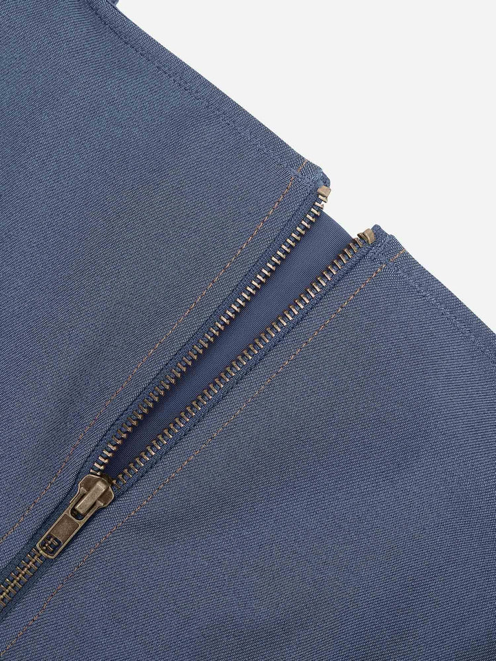 Blue denim shapewear romper detail with antique bronze zip front and contrast stitching.